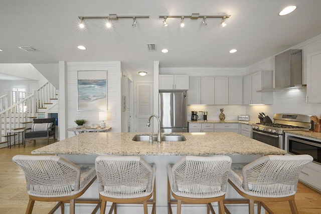 54 Dune Dr, Santa Rosa Beach, FL 32459 - kitchen with a sink, visible vents, stainless steel appliances, and wall chimney exhaust hood