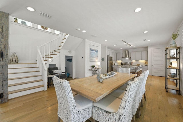 54 Dune Dr, Santa Rosa Beach, FL 32459 - dining space featuring light wood-type flooring, recessed lighting, stairway, and visible vents