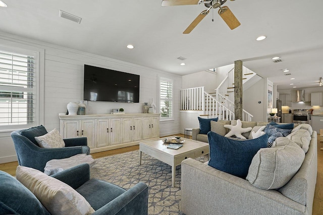 54 Dune Dr, Santa Rosa Beach, FL 32459 - living area with light wood-style flooring, a ceiling fan, stairs, and visible vents
