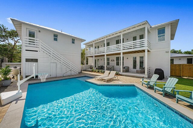 54 Dune Dr, Santa Rosa Beach, FL 32459 - back of house featuring a balcony, fence, stairs, a fenced in pool, and a patio area