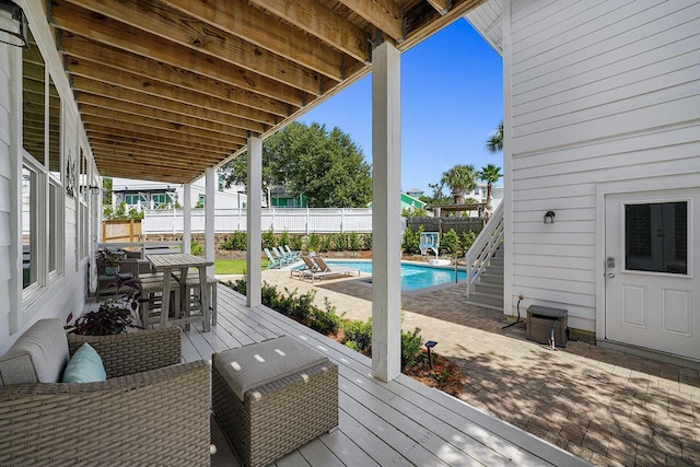 54 Dune Dr, Santa Rosa Beach, FL 32459 - wooden deck with a patio area, a fenced in pool, a fenced backyard, grilling area, and outdoor dining space