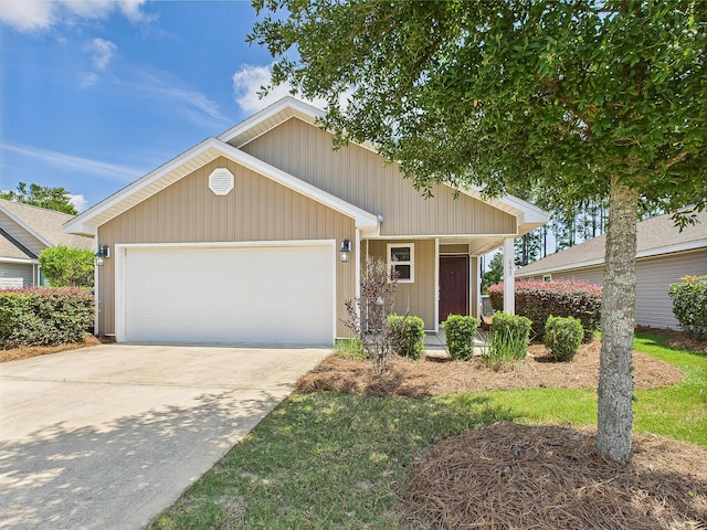643 Earl Godwin Rd, Freeport, FL 32439 - view of front facade featuring an attached garage, concrete driveway, and covered porch