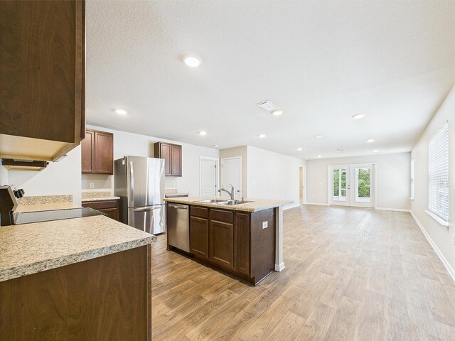 643 Earl Godwin Rd, Freeport, FL 32439 - kitchen with stainless steel appliances, a sink, light wood-style floors, light countertops, and a kitchen island with sink