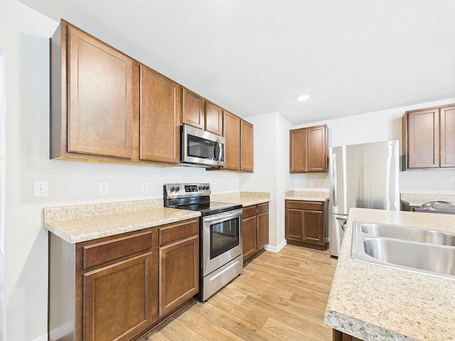 643 Earl Godwin Rd, Freeport, FL 32439 - kitchen featuring appliances with stainless steel finishes, a sink, light wood-style floors, light countertops, and recessed lighting