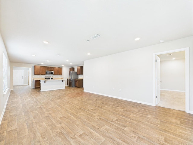 643 Earl Godwin Rd, Freeport, FL 32439 - unfurnished living room with light wood-type flooring, baseboards, and recessed lighting