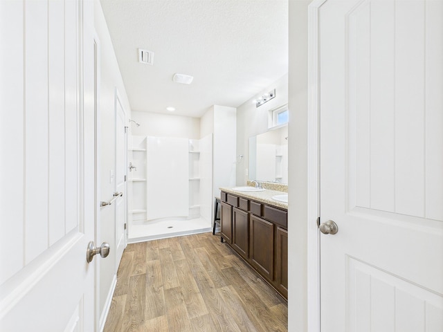 643 Earl Godwin Rd, Freeport, FL 32439 - full bathroom featuring walk in shower, wood finished floors, and double vanity