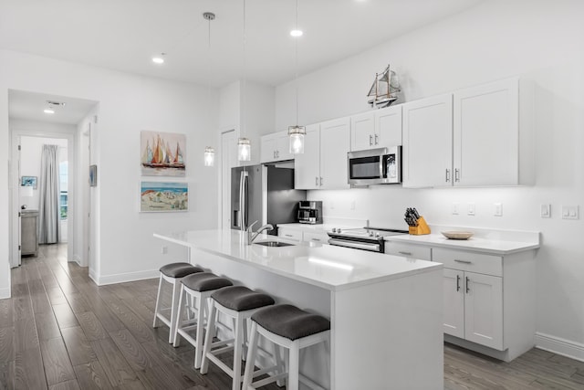 1740 S County Highway 393 # 301, Santa Rosa Beach, FL 32459 - kitchen with a kitchen breakfast bar, stainless steel appliances, a sink, a kitchen island with sink, and wood finished floors