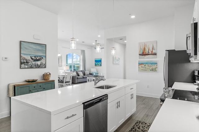 1740 S County Highway 393 # 301, Santa Rosa Beach, FL 32459 - kitchen featuring light countertops, a sink, appliances with stainless steel finishes, dark wood finished floors, and white cabinets