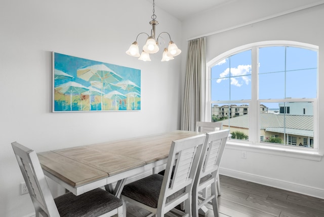 1740 S County Highway 393 # 301, Santa Rosa Beach, FL 32459 - dining area featuring baseboards, wood finished floors, and a chandelier