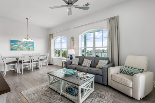 1740 S County Highway 393 # 301, Santa Rosa Beach, FL 32459 - living area featuring baseboards, visible vents, ceiling fan with notable chandelier, and wood finished floors