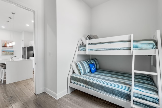 1740 S County Highway 393 # 301, Santa Rosa Beach, FL 32459 - bedroom with baseboards, a sink, light wood-style floors, and freestanding refrigerator