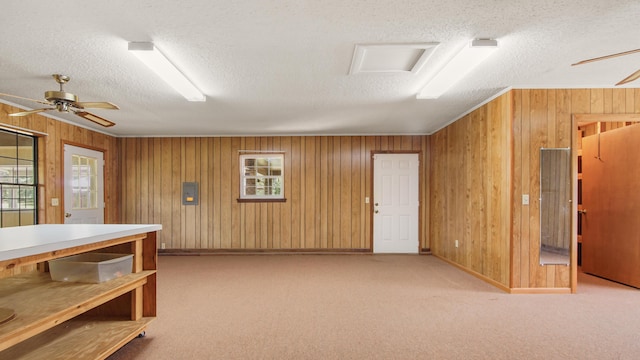 2374 County Highway 280a, Defuniak Springs, FL 32435 - interior space featuring a textured ceiling, a ceiling fan, wood walls, carpet, and baseboards