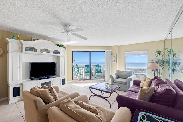 506 Gulf Shore Dr Unit 107, Destin, FL 32541 - living area with light tile patterned floors, plenty of natural light, ceiling fan, baseboards, and a textured ceiling