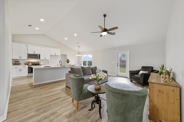 3202 Liz Ct, Crestview, FL 32539 - living area featuring light wood-style flooring, ceiling fan, high vaulted ceiling, recessed lighting, and a chandelier