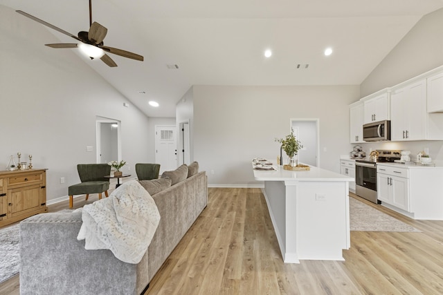 3202 Liz Ct, Crestview, FL 32539 - living area with high vaulted ceiling, light wood-style flooring, ceiling fan, recessed lighting, and baseboards