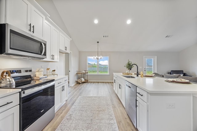 3202 Liz Ct, Crestview, FL 32539 - kitchen featuring stainless steel appliances, a sink, light countertops, white cabinets, and lofted ceiling