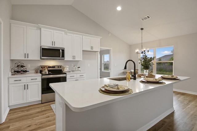 3202 Liz Ct, Crestview, FL 32539 - kitchen featuring stainless steel appliances, a sink, light countertops, light wood finished floors, and white cabinets