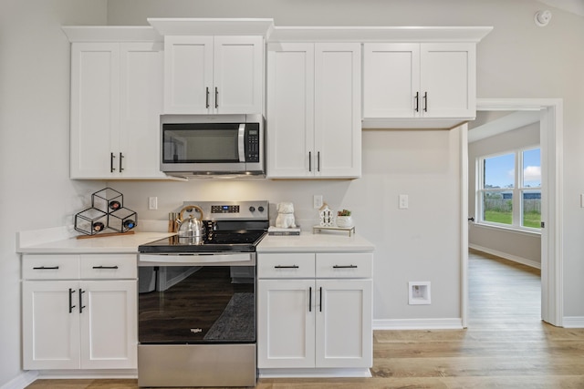 3202 Liz Ct, Crestview, FL 32539 - kitchen featuring stainless steel appliances, light wood-type flooring, baseboards, and white cabinets