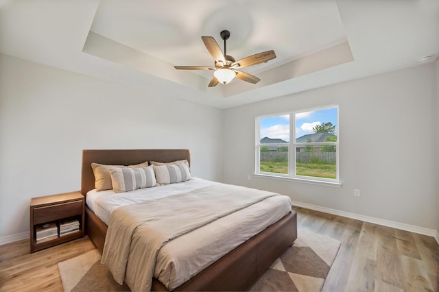 3202 Liz Ct, Crestview, FL 32539 - bedroom with a raised ceiling, light wood-style floors, baseboards, and a ceiling fan
