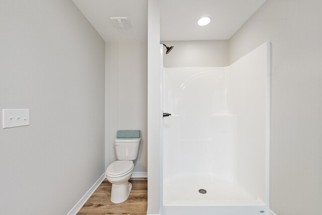 3202 Liz Ct, Crestview, FL 32539 - bathroom featuring a shower, wood finished floors, toilet, and baseboards