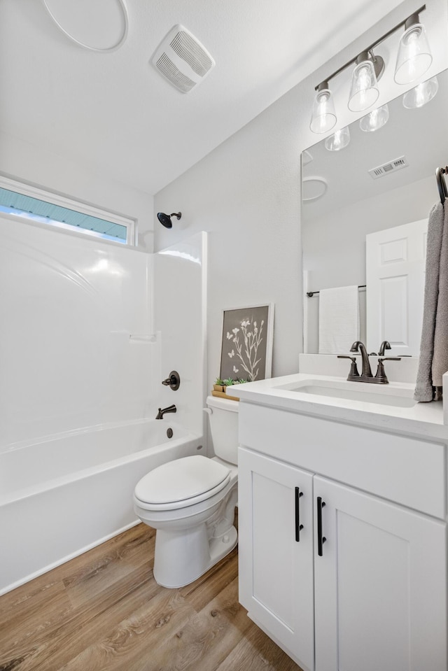 3202 Liz Ct, Crestview, FL 32539 - bathroom featuring wood finished floors, vanity, shower / washtub combination, and toilet