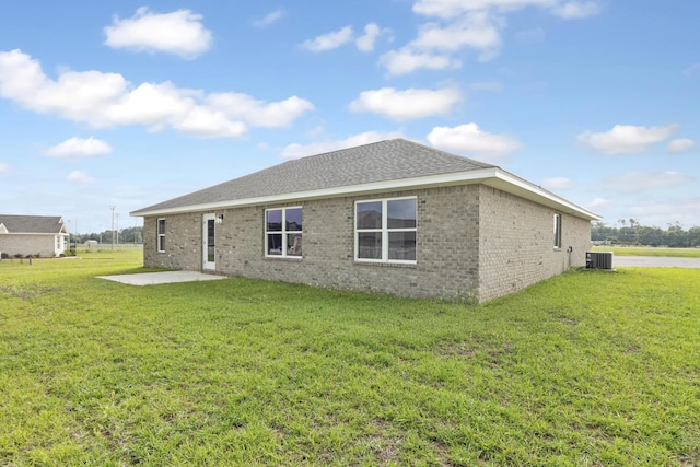 3202 Liz Ct, Crestview, FL 32539 - back of house with a patio area, cooling unit, brick siding, a yard, and roof with shingles