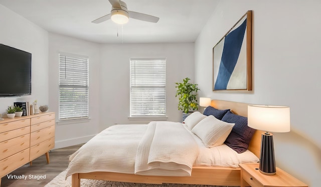bedroom featuring a ceiling fan, wood finished floors, and baseboards