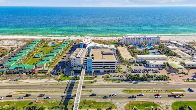 birds eye view of property with a water view and a view of the beach