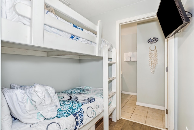 bedroom featuring baseboards and tile patterned flooring