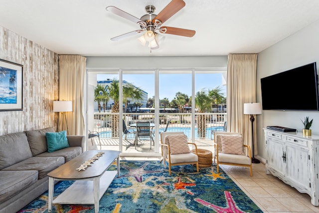 living area with ceiling fan and light tile patterned floors