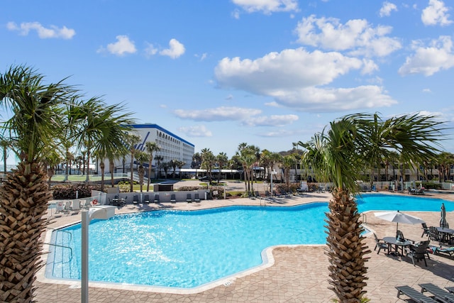pool featuring fence and a patio area