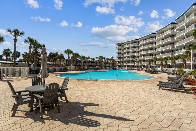 pool featuring a patio and fence