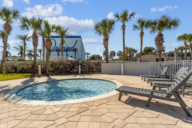 view of swimming pool featuring fence and a patio area