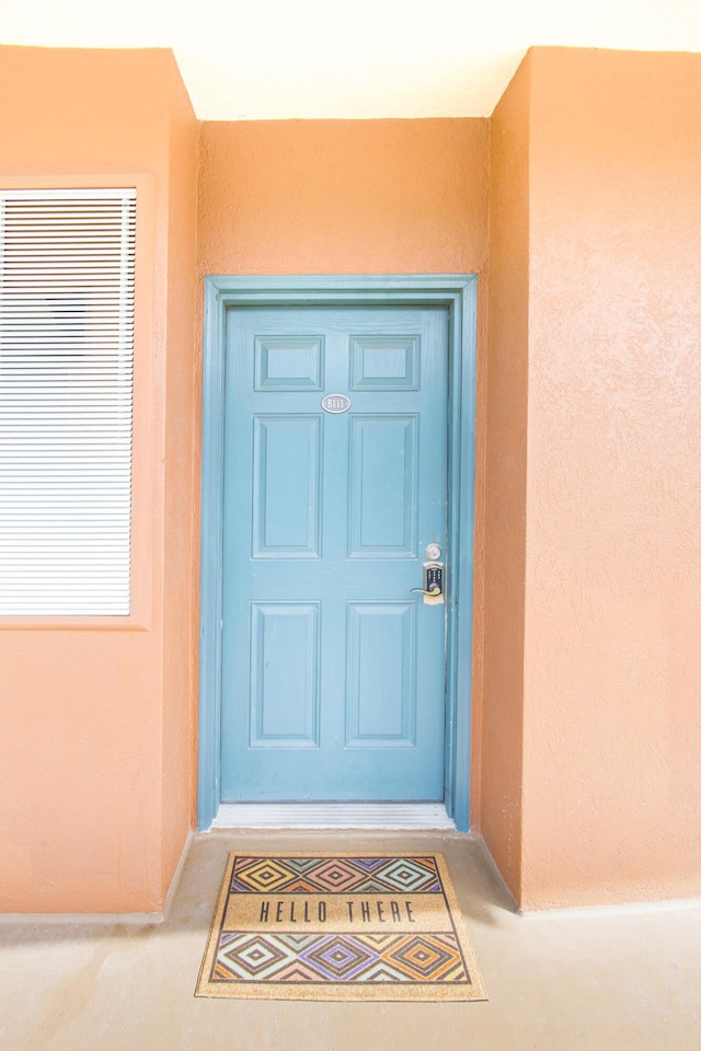 property entrance featuring stucco siding