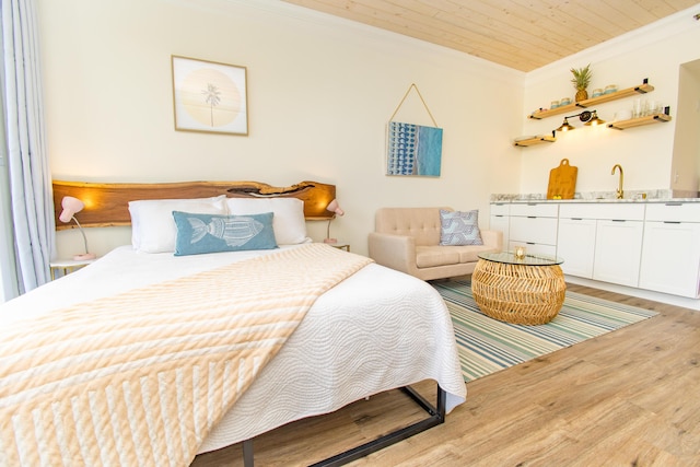 bedroom featuring crown molding, a sink, indoor wet bar, wood finished floors, and wood ceiling