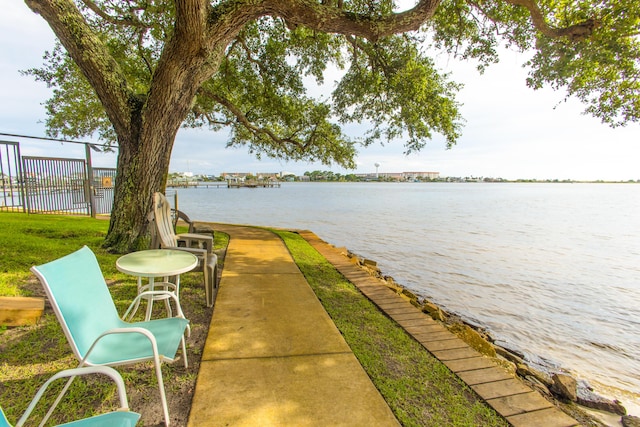 water view featuring fence and a boat dock