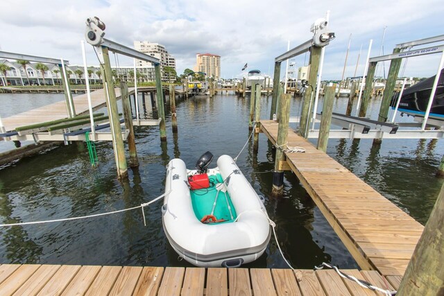 dock area with boat lift and a water view