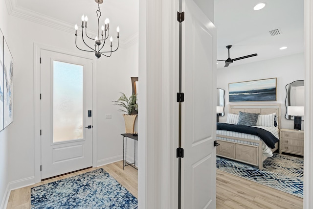 197 Suwannee Dr Lot 18, Watersound, FL 32461 - entrance foyer featuring light wood-type flooring, ornamental molding, ceiling fan with notable chandelier, and visible vents