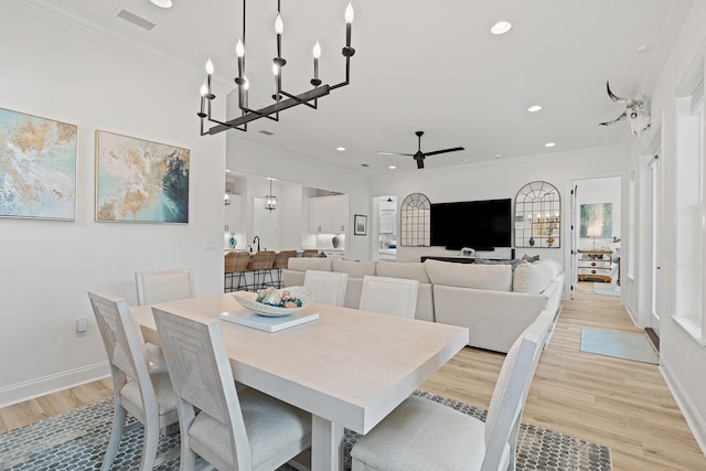 197 Suwannee Dr Lot 18, Watersound, FL 32461 - dining room with ornamental molding, visible vents, light wood-type flooring, and ceiling fan with notable chandelier