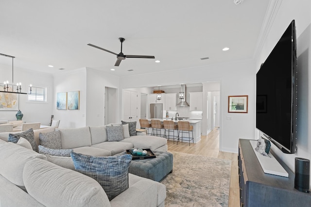197 Suwannee Dr Lot 18, Watersound, FL 32461 - living room featuring recessed lighting, crown molding, light wood-style floors, and ceiling fan with notable chandelier