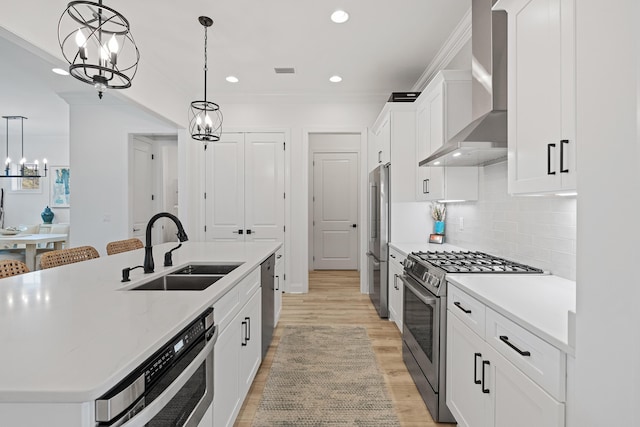 197 Suwannee Dr Lot 18, Watersound, FL 32461 - kitchen with a sink, appliances with stainless steel finishes, wall chimney range hood, ornamental molding, and a kitchen island with sink
