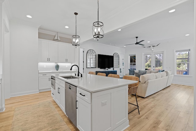 197 Suwannee Dr Lot 18, Watersound, FL 32461 - kitchen with light wood finished floors, dishwasher, a ceiling fan, a sink, and a kitchen breakfast bar