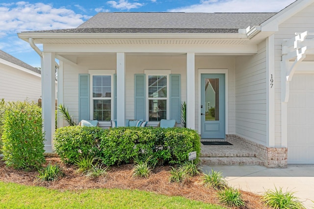 197 Suwannee Dr Lot 18, Watersound, FL 32461 - view of exterior entry featuring a shingled roof, covered porch, and an attached garage