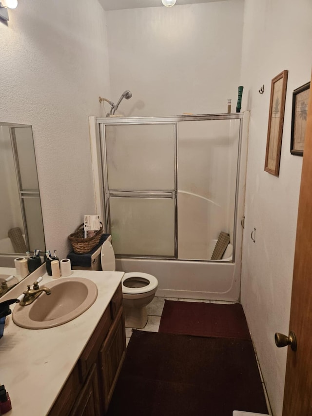 full bathroom with toilet, vanity, shower / bath combination with glass door, and tile patterned flooring