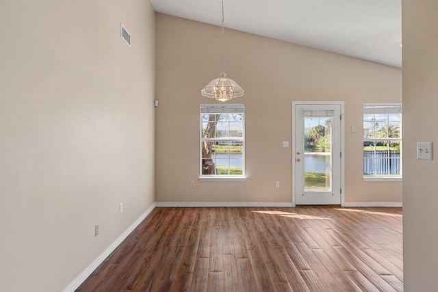 309 Wimico Cir, Destin, FL 32541 - unfurnished dining area with high vaulted ceiling, wood finished floors, a chandelier, baseboards, and visible vents