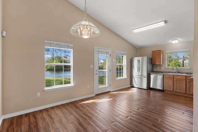 309 Wimico Cir, Destin, FL 32541 - kitchen featuring brown cabinetry, a notable chandelier, stainless steel appliances, and dark wood-type flooring