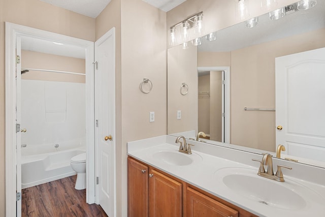 309 Wimico Cir, Destin, FL 32541 - bathroom featuring double vanity, wood finished floors, toilet, and a sink