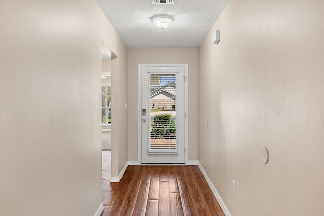 309 Wimico Cir, Destin, FL 32541 - entryway featuring visible vents, wood finished floors, baseboards, and a textured ceiling