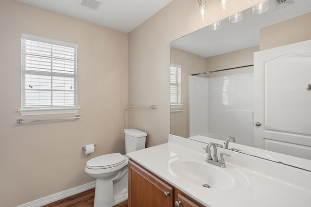 309 Wimico Cir, Destin, FL 32541 - bathroom with visible vents, toilet, vanity, baseboards, and walk in shower