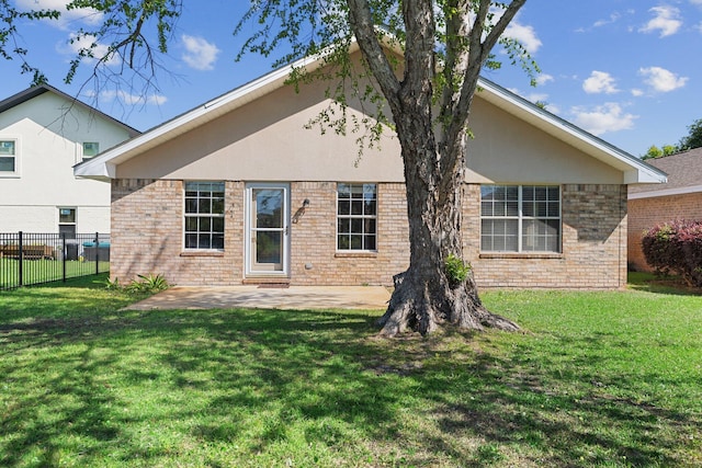 309 Wimico Cir, Destin, FL 32541 - rear view of house with brick siding, fence, a yard, and a patio